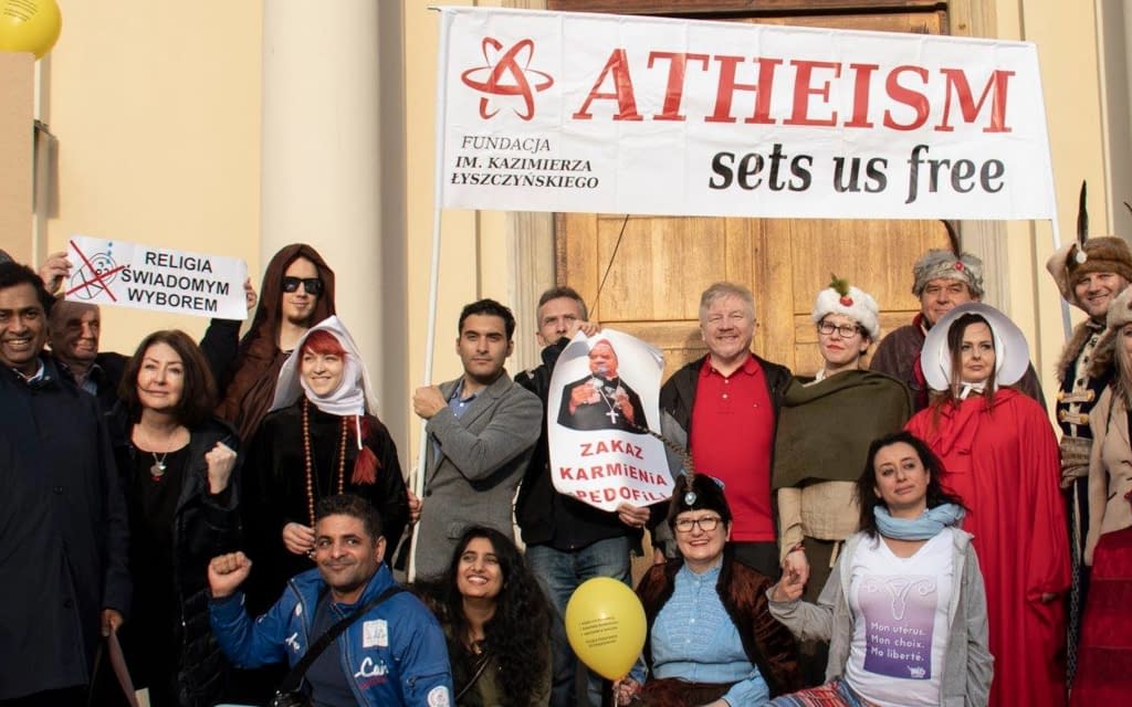 Photo of people under an Atheism sets us free banner